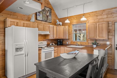 Open kitchen with stove, refrigerator and microwave (no dishwasher).