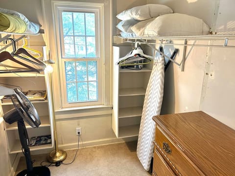Master bedroom walk-in closet! -ironing board-iron-baby fence guard for the stairs