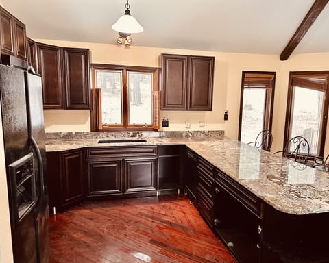 Fully stocked kitchen with a huge granite countertop and bar seating for 5.