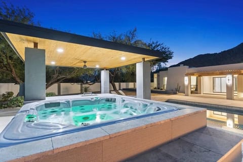 Enjoy the serene ambiance in the 5 person hot tub next to the firepit and tranquil pool