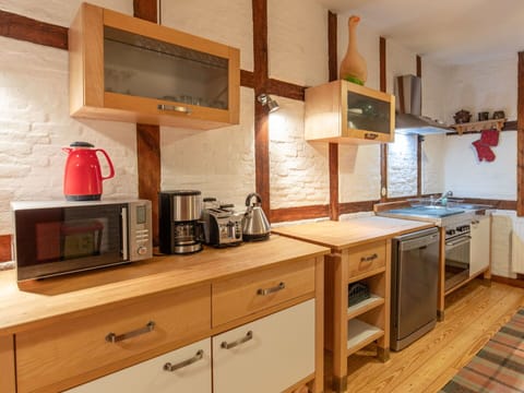 Countertop, Cabinetry, Furniture, Kitchen Appliance, Kitchen Stove, Kitchen, Home Appliance, Wood, Interior Design, Flooring