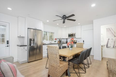 Dining table and kitchen area, which has direct access to the garage.