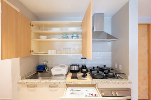 Fully equipped kitchen with appliances and utensils
