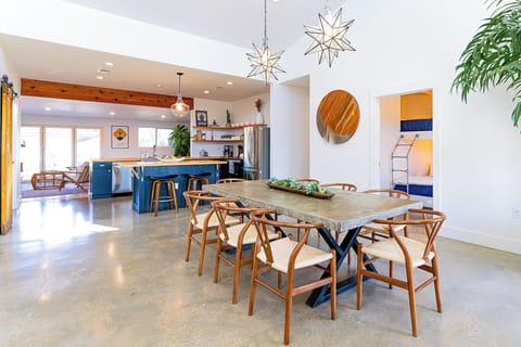 The dining table seats 8 people and there is also bar seating available