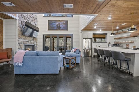 Living Room: Relax by the fireplace and enjoy the scenic views through spacious glass doors!