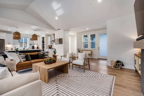 Living area with a 65 inch smart TV, SONOS surround sound system, gas fire place, board games.