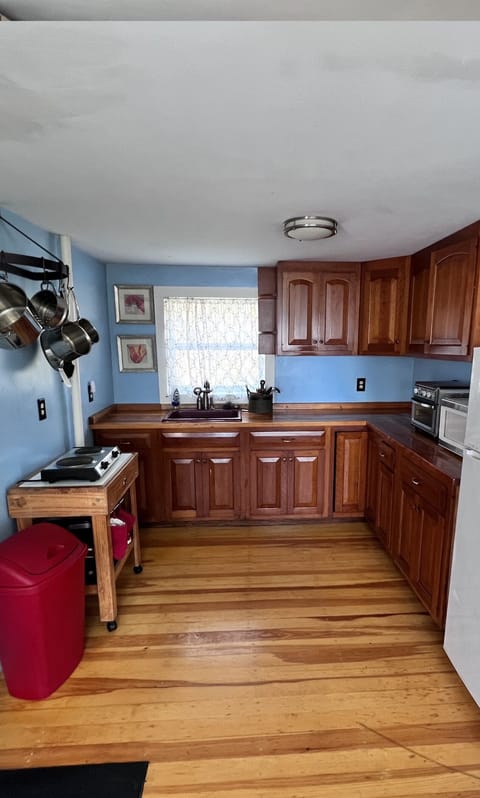 Fully stocked kitchen with pans and dishes 