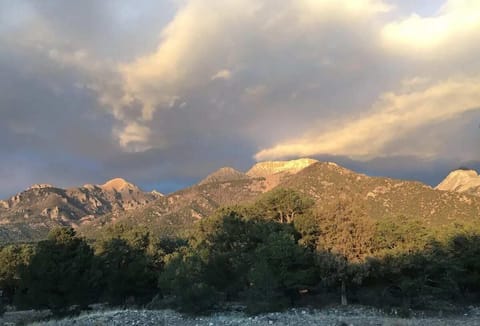 Majestic mountains kissed by sunlit clouds...