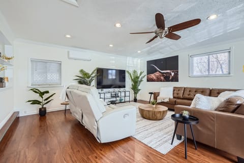 Large, inviting family room with 75" TV and plenty of comfortable seating.

