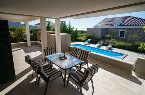 A heated pool, sun loungers