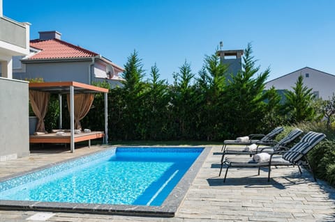 A heated pool, sun loungers