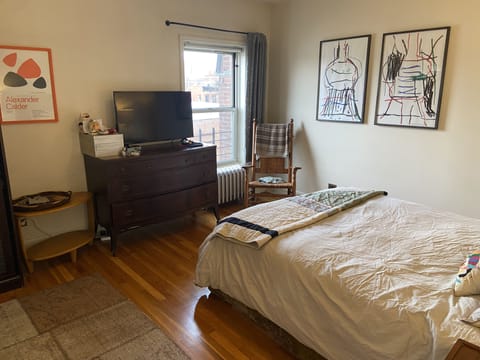 Master bedroom has view of brownstone Brooklyn