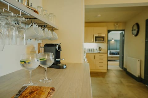 Open plan kitchen with oven, 4 ring hob, fridge, freezer, microwave & dishwasher