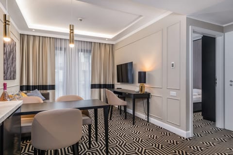 A dining area with elegant chairs, a table, and bright natural light from large windows.