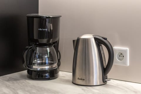 A coffee station with a coffee maker and electric kettle, ensuring guest convenience.