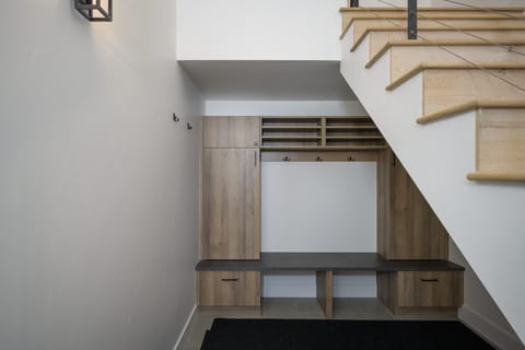 Mud room can be found under the stairs in the entryway