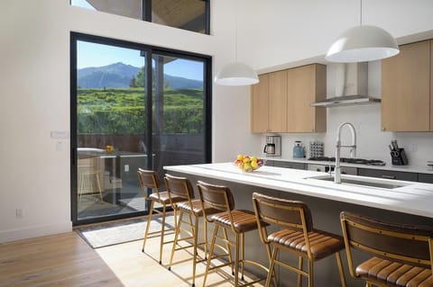 Additional seating for five at the breakfast bar and deck access