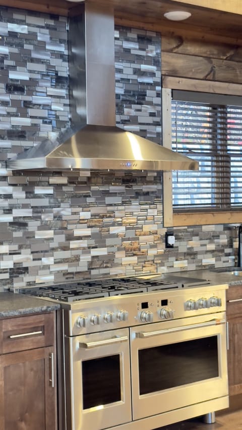 Large gas stove with electric oven for cooking/baking.