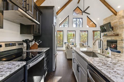 Gourmet Kitchen: Sleek granite counters and large windows invite culinary creativity and scenic views!