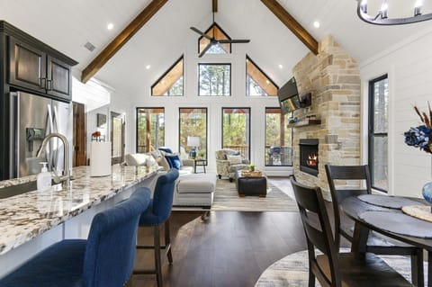 Living Room: Sun-kissed space with scenic views, inviting seating, and a chic fireplace!