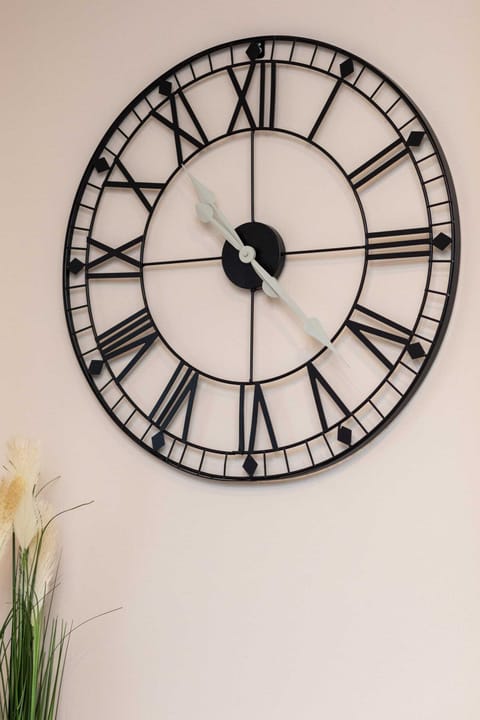 A decorative wall clock, adding a modern yet rustic charm to the space.