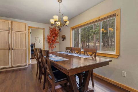 The dining table has six chairs and a lovely view of the backyard.