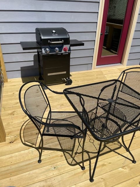 Private deck that overlooks the lake with seating , gas grill & firepit