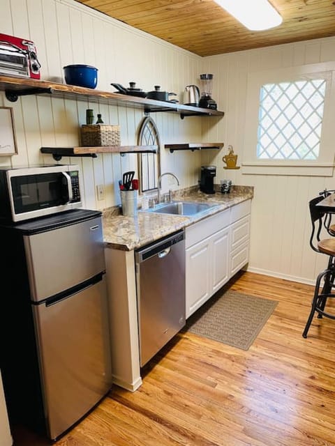 Kitchen complete with dishwasher, garbage disposal, microwave, refrigerator, Keurig, toaster oven, single burner hot plate, hot water kettle, blender, dishes, pots & pans & utensils