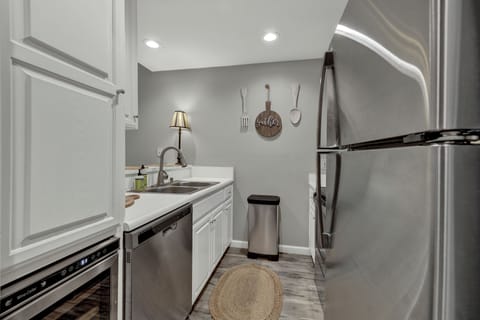 Fully stocked kitchen w/wine fridge.