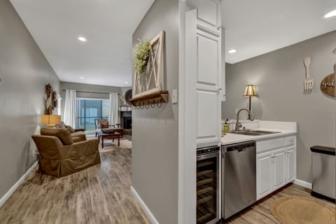 Entryway with view into living room and kitchen.