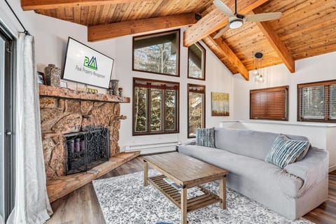 Cozy living area with high ceilings and a stylish fireplace