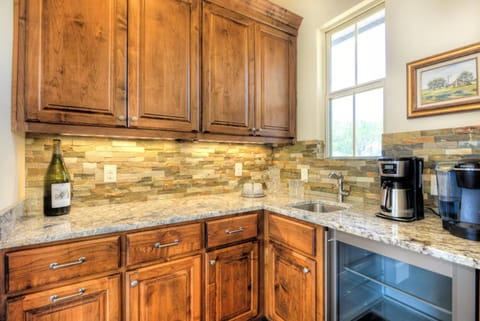 Coffee bar equipped with Keurig and Drip coffee makers, wine fridge