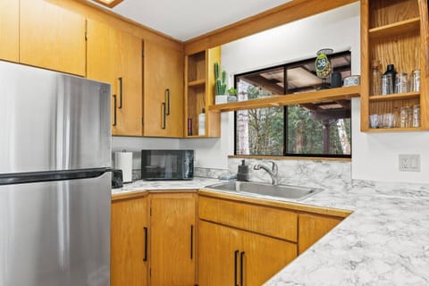 Full-size refrigerator, microwave, toaster, Keurig, and electric stove.