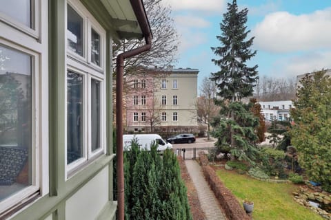 A scenic view of the garden and surrounding area from a window.
