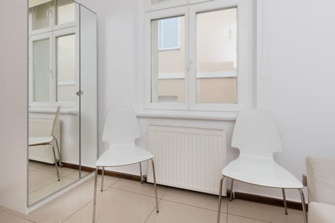 A modern chair and small side table positioned next to a window for natural light.
