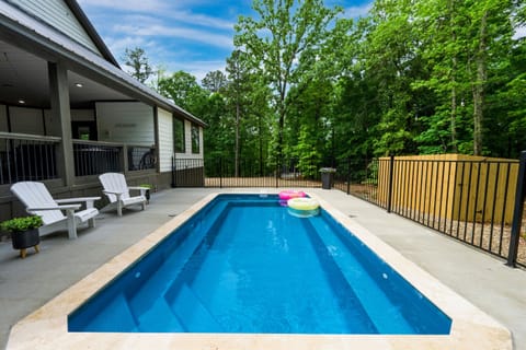 Outdoor Oasis: Dive into relaxation with your private pool surrounded by lush greenery!