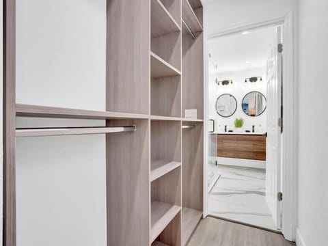 Closet in primary bedroom that leads into a gorgeous en suite bathroom