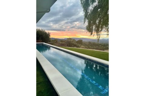 55' lap pool with sunset view.  Pink moment view through the house from pool