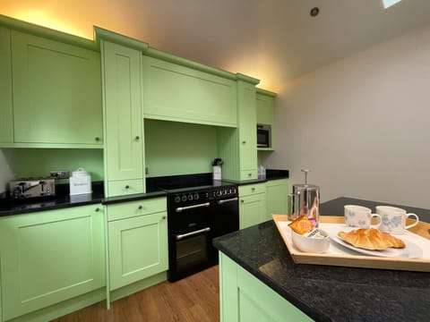 The kitchen features an electric hob, double oven and grill as well as microwave, toaster and fridge/freezer