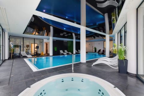 A luxurious indoor pool area with a hot tub, perfect for relaxation.
