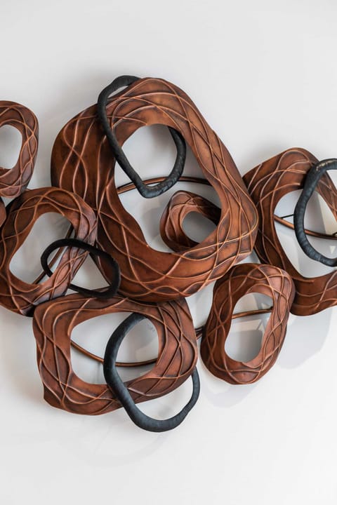 A close-up of intricate wall art in the bedroom, adding a stylish touch.
