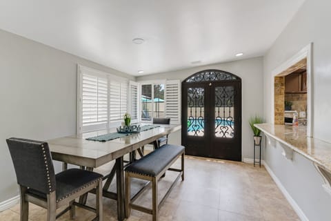 Stylish gray table with chairs and bench, perfect for meals and gatherings.