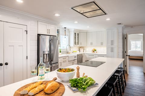 Spacious kitchen with modern appliances and barstool seating.