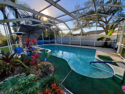 Solar heated caged pool with garden, heater, umbrella, nite lights, pool floats
