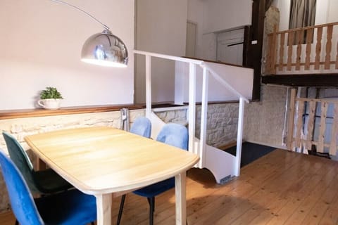 Upstairs landing with a table, cupboard filled with childrens toys, and a bunk bed.