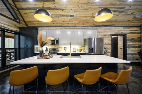 Fully equipped kitchen with high-end appliances, generous counter space, and all the tools needed to prepare group meals with ease.