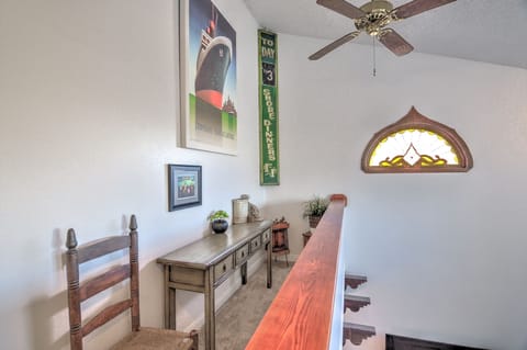 Upstairs balcony that overlooks the livingroom with art and beautiful stained glass window