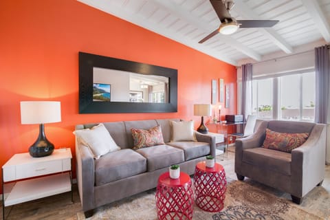 Relax in this lounge area featuring a large couch and a comfortable armchair.