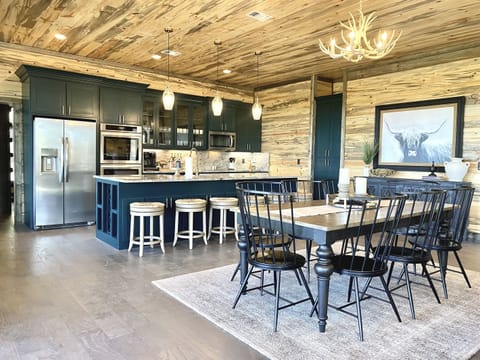 Open concept kitchen and dining with seating for six at the island.