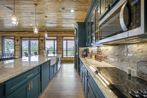 The well-equipped kitchen, which includes double ovens, an apron sink, a large island, and a guest pantry, will be perfect for cooking big meals for your group.